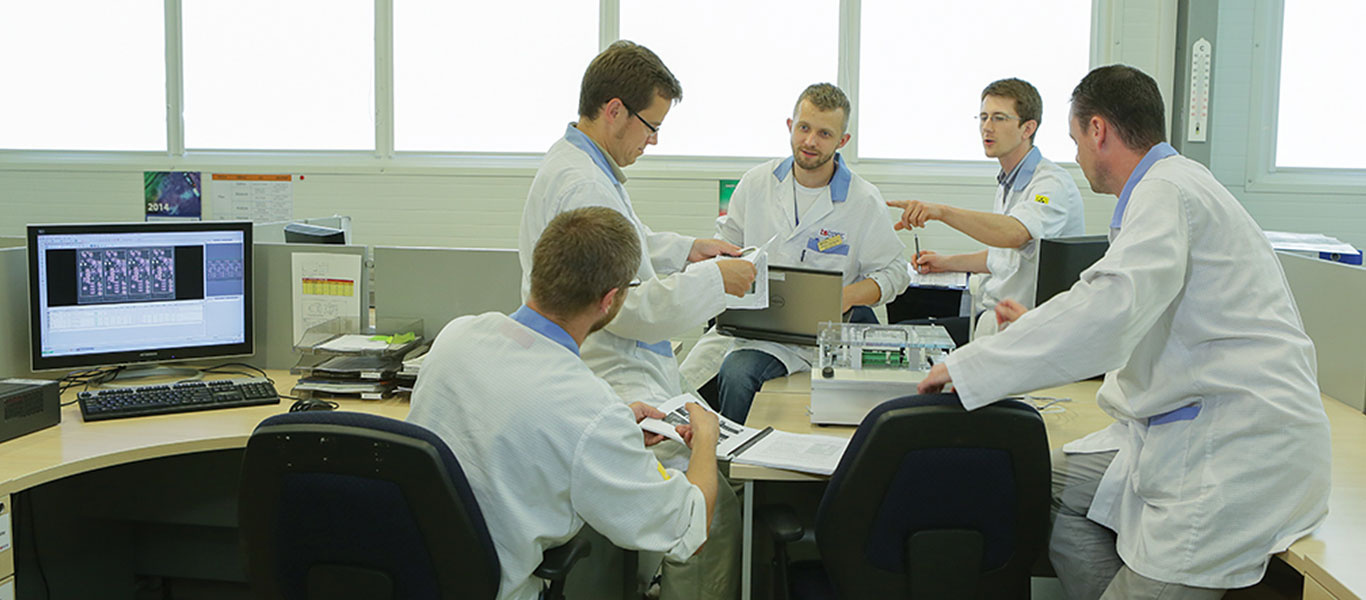 A team of engineers working on PCB production