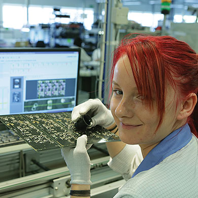 Woman working in PCB production
